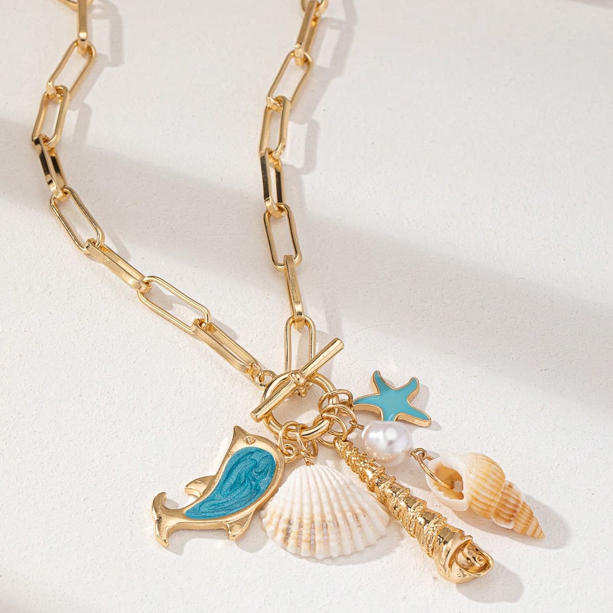Gold Tone Paperclip Chain Toggle Necklace with Ocean Charms Dolphin Starfish